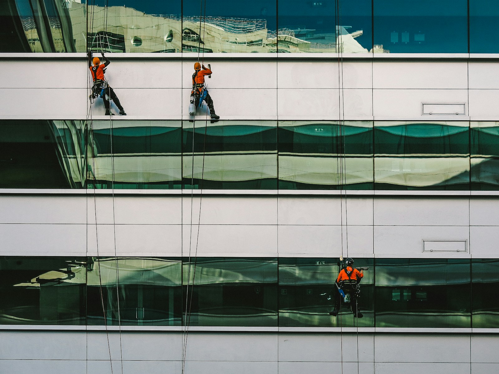 man cleaning white building